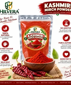 Hilvera Kashmiri Mirch Powder pouch with heap of red chilli powder in wooden bowl and whole dried red chillies