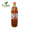 Kathait Gold 1 litre transparent plastic bottle of cold pressed mustard oil with red cap on a plain white background. Cold Pressed Rajasthan Rayda Black Mustard Oil